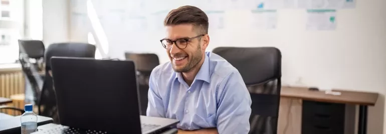 Professionista sorridente lavora al PC