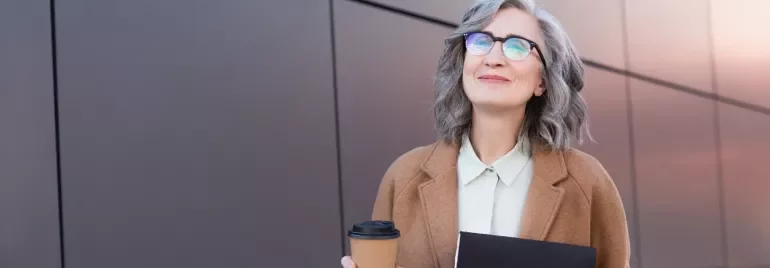 Professionista senior sorridente con caffè