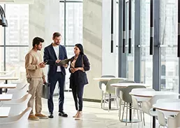 3 coworkers talking in a office lobby