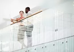 2 person talking in an office building