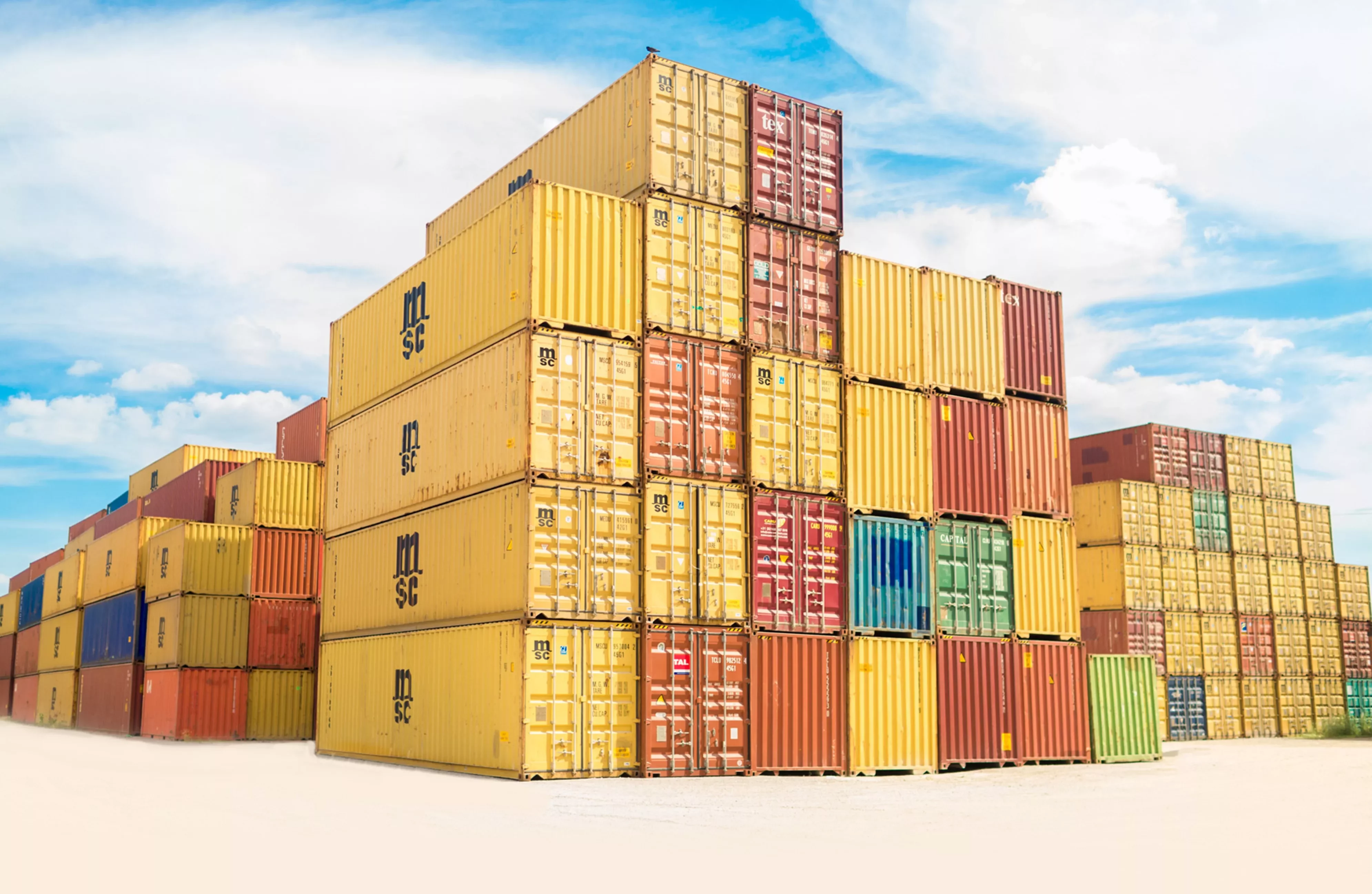 Container impilati in un porto con cielo sereno